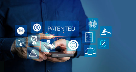 Patented patent copyright law business technology concept. businessman touch virtual screen of patented word with copyright icons for author rights and patented intellectual property.の写真素材