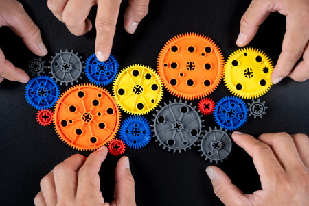 Teamwork, hands of business people together with gear for strategy, planning and collaboration at...