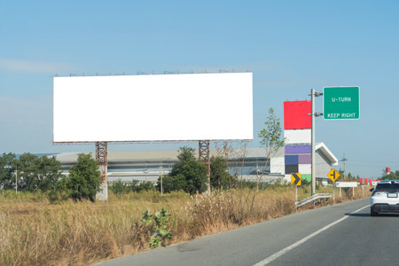 Large horizontal blank sign on a highway in Bangkok, Thailand. Traffic and sky. Blank billboard on the highway. Outdoor Billboard Mockup with Blue Sky and Clouds. Clipping path.の写真素材