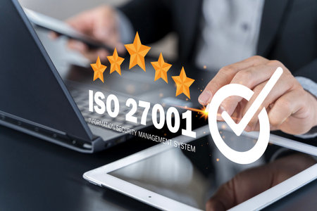ISO 27001 concept. Businessman with ISO 27001 certified for information security management system...