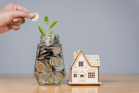Preset money saving concept with stacking silver coins with female hands. Growing business. Small...