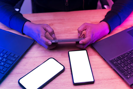 Man playing game on mobile phone. A modern smartphone with a white screen, placed on a vibrant...