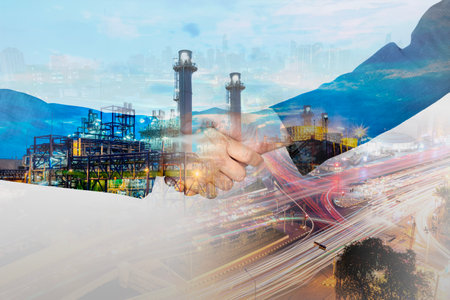 Businessman and industrial worker handshake against illuminated refinery background, oil extraction...