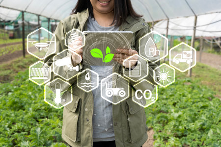 iot smart industry robot 4.0 agriculture concept,industrial agronomist,farmer using tablet to monitor, control the condition in vertical or indoor farm ,the data including Ph, Temp, Ic, humidity, co2の写真素材