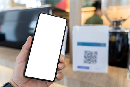 Customer self-scanning apps for self-checkout. Close-up of woman holding smartphone with blank screen to scan for payment. cell phone screen. White screen, clipping path.の写真素材