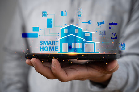 Hand holding smartphone with smart home interface, showing connected devices and automation technology. Concept of modern living, convenience, innovation, and home network management.の写真素材