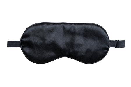 Black sleeping eye mask with adjustable strap isolated on white background. Comfortable accessory designed to block out light and improve sleep quality during travel, nap, or bedtimeの写真素材