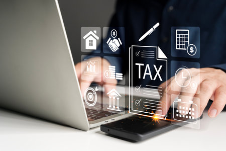 Businessman using laptop and smartphone for digital tax filing, finance management, and accounting....