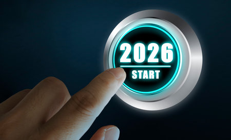 Close-up of a human finger pressing a futuristic glowing button labeled 2026 start. Concept of new year, fresh start, innovation, digital transformation, progress, and future goals.の写真素材