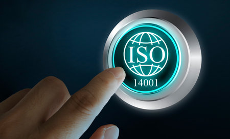 Close-up of human hand pressing ISO 14001 button on virtual screen. Concept of environmental management, sustainability standards, quality control, and international compliance certification system.の写真素材