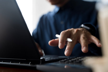 Closeup of businessman working on laptop with digital pen for financial data analysis, investment planning, technology innovation, banking management, economic growth, digital transformation concept.の写真素材