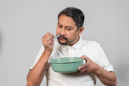 Close up man washing nose with nasal saline syringe irrigation, concept of healthcare, allergy...