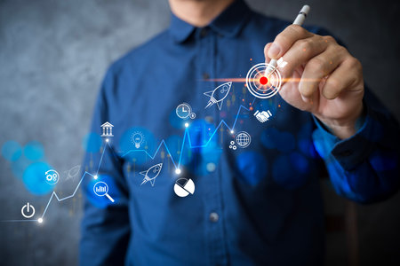 A businessman drawing upward graph with business growth, target icons symbolizing innovation, planning startup success, leadership, goal achievement, modern financial development through data strategyの写真素材