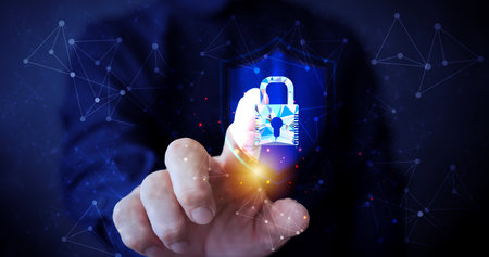 Cybersecurity concept showing hand touching digital lock icon with network connections representing...