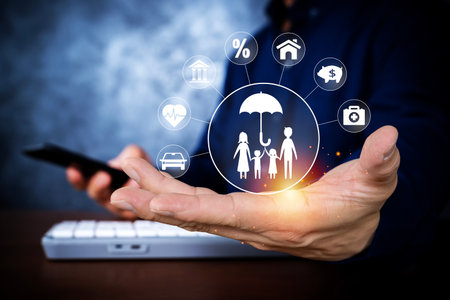 Digital family insurance protection icons floating above a businessmanâs hand representing health, home, finance, security, and future planning, risk management, and modern insurance solutions.の写真素材