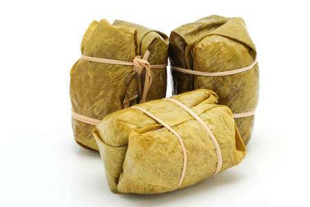 glutinous rice steamed in banana leaf is a Thai snack made from sticky rice,banana,black bean and shredded coconut.の写真素材