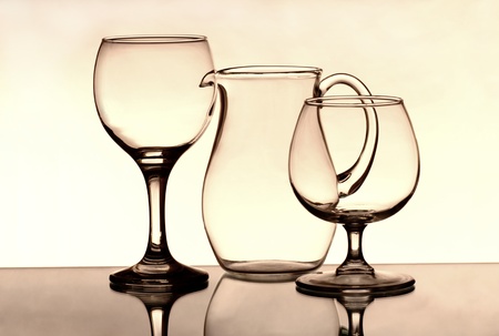Two wineglasses and a jug on the mirrorの写真素材