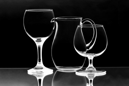 Two empty wieglasses and a jug on the mirrorの写真素材