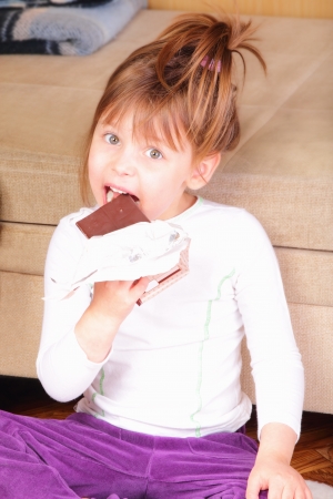 Pretty little girl with chocolateの写真素材