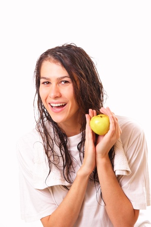 Happy young brunette woman with an appleの写真素材