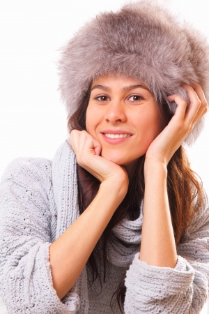 Attractive brunette woman in a fur hatの写真素材