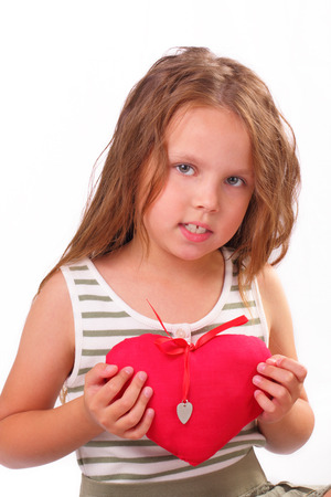 Beautiful little girl with a gift for St. Valentine's Dayの写真素材