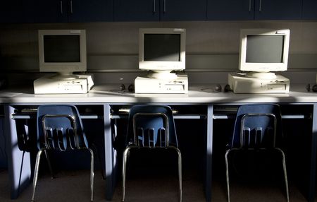 Computers in a row set in a classroom that is for learning.