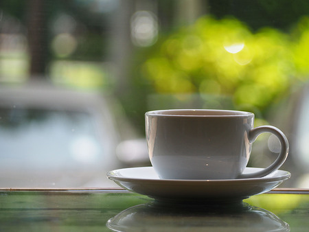 Cup of coffee on the table Background bokehの写真素材
