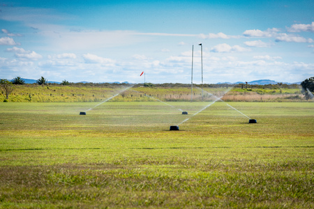 A rugby and soccer fields being watered after a gameの写真素材