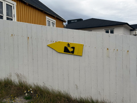 A Evacuation Route sign posted at a fence in Uummannaq, Greenlandの写真素材