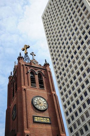 Antipoles: an old church and a modern skyscraperの写真素材