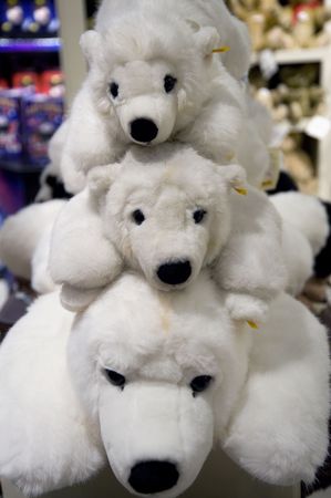 Three stuffed polar bears in a toy storeの写真素材