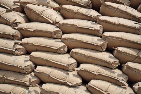 A large stack of brown jute sacksの写真素材