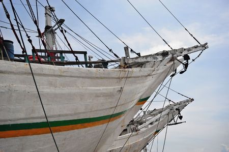 Old wooden schooners at the Jakarta harbour with a clear blue skyの写真素材