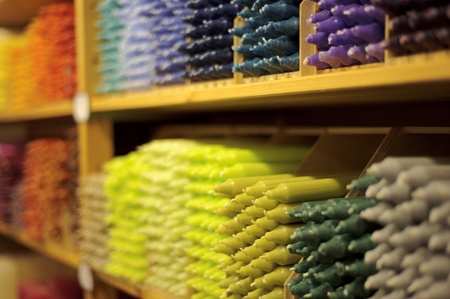 Colorful stack of candles on shelve in storeの写真素材