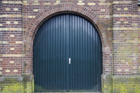 A closed gate inside a medieval brick wall