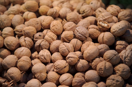 A stack of walnuts in their shell