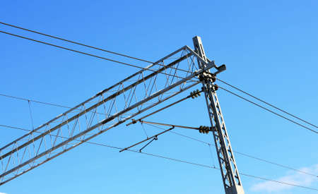 railway pylons of the high tension line with blue skyの写真素材