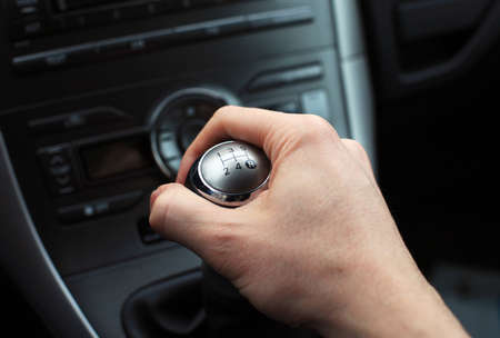 close up of hand on manual gear shift knob