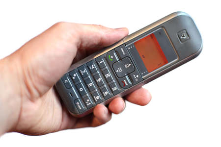hand holding cordless phone isolated on white backgroundの写真素材