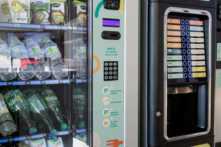 Alicante, Spain â October 4, 2023: Explore the role of vending machines in modern workplaces. In a bustling corporate cafeteria, employees rely on convenient snacks and beverages, enhancing productivity and satisfactionのeditorial素材