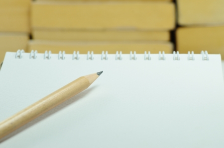 Pencil with notebook and stack of books background.の写真素材