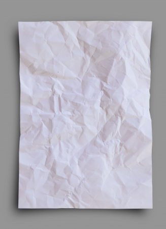 Crumpled and wrinkled white paper on gray background.の写真素材