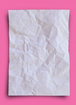 Crumpled and wrinkled white paper on pink background.の写真素材
