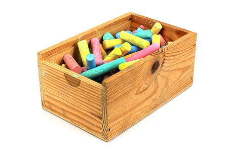 Colorful chalk in wooden box isolated on white.の写真素材