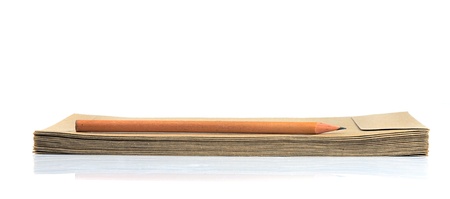 Pile of brown envelopes and wooden pencil isolated on white.の写真素材