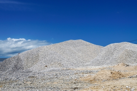 Pile of construction gravel with blue sky の写真素材