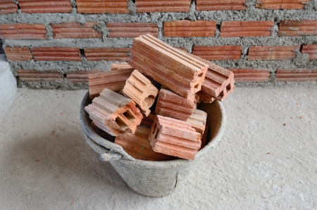 Red brick  in basket at constructing site.の写真素材