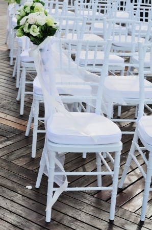 White wedding chair decorated with flowerの写真素材