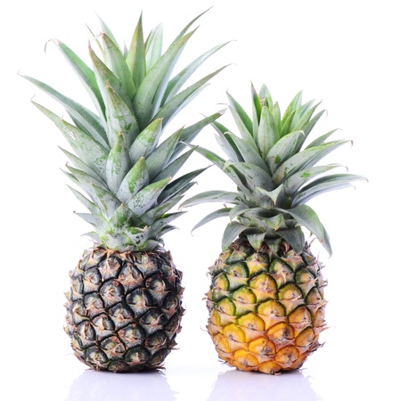 Two raw pineapple on white with reflectionの写真素材